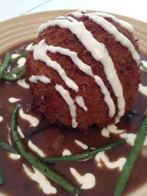 Beefy Doo-Dad....bierock style beef surrounded by 
mashed potatoes, rolled in panko crumbs, flash fried then 
placed on top a plate of mushroom gravy, with skillet green 
beans drizzled with horseradish cream sauce.
