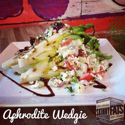 Aphrodite Wedgie - Romaine wedge sprinkled with chopped cucumbers, tomatoes, red onions, kalamata olives, feta and drizzled with a balsamic glaze.  (Healthy Salad)